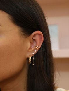 a close up of a person wearing some kind of earring with pearls on it