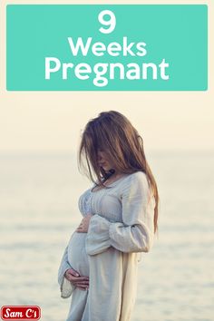 a pregnant woman standing on the beach with her hands in her stomach and text that reads, 9 weeks pregnant