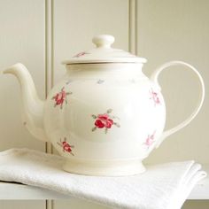 a tea pot sitting on top of a white towel