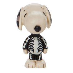 a white and black dog with headphones on it's ears is wearing a skeleton shirt