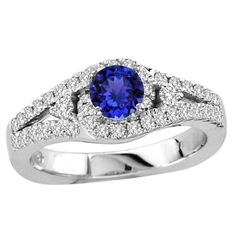 A magnificent ring with a round tanzanite of around 0.450 carats enclosed with 42 diamonds of almost 0.420 carats, some studded on band renders it an extremely look. Tanzanite Studs, Tanzanite Earrings, Round Rings, Pretty Rings