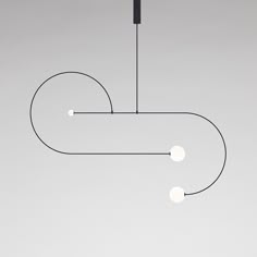 a black and white light hanging from a ceiling