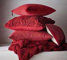 four red pillows stacked on top of each other