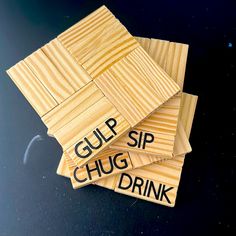 four wooden coasters with words on them that read gup sip, chug, drink