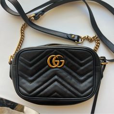 A Classic Bag, Still In Excellent Condition. The Only Visible Wear Is To The Interior Lining (As Shown In Photos)! No Damage To Hardware Or Exterior. The Mini Gg Marmont Chain Shoulder Bag Has A Softly Structured Shape And A Zip Top Closure With Double G Hardware. The Chain Shoulder Strap Has A Leather Shoulder Detail. The Camera Bag Is Made In Matelass Leather With A Chevron Design And Gg On The Back. Black Matelass Chevron Leather With Gg On The Back Antique Gold-Toned Hardware Double G Interior Open Pocket Chain Shoulder Strap With 23.6" Drop Zip Top Closure Weight: 1.2 Lb Approximately Mini Size: 7"W X 5"H X 2.5"D Made In Italy The Model Is 5' 10" Tall Fits Up To: Iphone Pro Max/Pl Gucci Gg Marmont Mini, Gg Marmont Mini, Pocket Chain, Iphone Pro, Gucci Gg Marmont, Chevron Design, Classic Bags, Gg Marmont, Mini Shoulder Bag