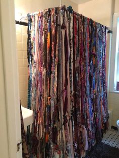 a shower curtain made out of ties in a bathroom