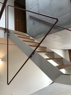 a white staircase with metal handrails in a building