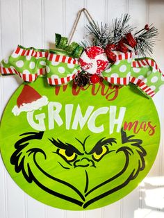 a grinch christmas ornament hanging on a door