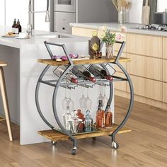 a kitchen island with wine glasses and bottles on the rack in front of an island