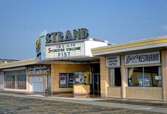 an old movie theater with the marquee for strand theatre on it's side