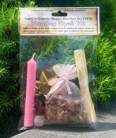 a bag filled with treats and a pink candle next to some trees in the background