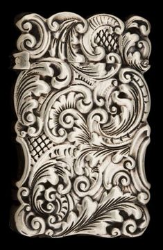 an intricately carved white tile with swirls and flowers on it's sides