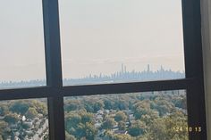 a window with a view of the city from it