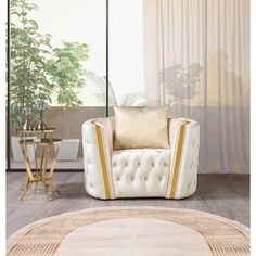 a white chair sitting on top of a wooden floor next to a table with a potted plant