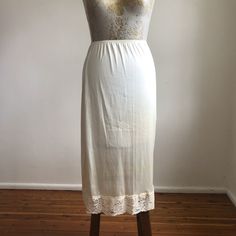 - Vintage 90's slip skirt  - a lovely off white/light beige shade  - lace trim round hem  - elastic waist  - the fabric is polyester slightly sheer  - fits best an AUS 10 US 6 UK 10 EU 38                                       - MEASUREMENTS -  WAIST - 22 in to 32 in   HIPS - 40 in  LENGTH - 30 in  I wash and clean all my dresses so they will always arrive fresh and ready to wear  I combine postage -  $2 extra each item within Australia  $8 extra each item international  *If package is lost once Beige Flowy Lace Skirt, Summer Fitted Skirt With Delicate Lace, Fitted Summer Skirt With Delicate Lace, Fitted Cream Bottoms With Lace Trim, Stretch Lace Trim Skirt, Fitted Beige Lace Bottoms, Fitted Delicate Lace Skirt For Summer, Summer Skirt With Lace Trim And Stretch, Stretch Skirt With Lace Trim For Summer