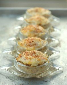 small glass dishes filled with food on top of a table