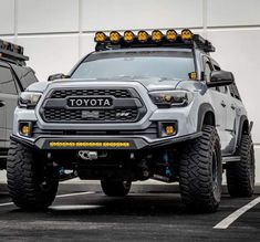 two gray toyota trucks parked next to each other