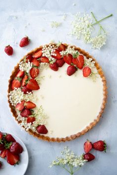 a cheesecake with strawberries and baby's breath on top