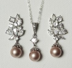 Champagne Powder Almond Pearl CZ Silver Earrings and Necklace Pendant Wedding Bridal Jewelry Set with .925 Sterling Silver Chain. PLEASE READ ITEM DESCRIPTION and SHOP POLICIES before placing your order, and contact me with any questions! EARRINGS are about 1.18 inch (3cm) long from top of earring stud to bottom. CHAIN is 18 inches (45.7cm) long. PENDANT is 1 inch (2.5cm) long including bail. Pearls are 8mm. MATCHING BRACELET: https://www.etsy.com/listing/531968787/champagne-pearl-bridal-bracelet-blush?click_key=0feb74431fb29761d38403b941745f5a6cd586fe%3A531968787&click_sum=ab9755d8&ref=shop_home_active_4&sca=1&sts=1 CHAMPAGNE JEWELRY: https://www.etsy.com/shop/LanaChayka?ref=seller-platform-mcnav&search_query=champagne JEWELRY SETS SECTION: https://www.etsy.com/shop/LanaChayka?ref=seller- Champagne Jewelry, Pearl Wedding Jewelry Sets, Pearl Jewelry Set, Pearl Bridal Jewelry, Pearl Jewelry Wedding, Pearl Jewelry Sets, Earring Stud, Pearl Bridal, Champagne Wedding