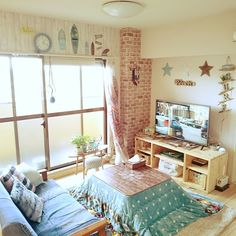 a living room filled with furniture and a flat screen tv sitting on top of a wooden table