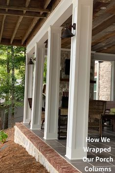 the porch is covered with white pillars and columns