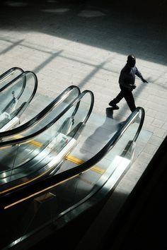 an escalator with people walking down it