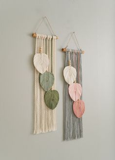 two wall hangings with different colored leaves on them