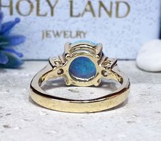 Don't miss this opportunity to own this beautiful gemstone ring crafted in 14k gold filled => Gemstone Type - Opal, Clear Quartz => Gemstone Cut - Cabochon, Faceted => Gemstone Size - 10 mm, 3 mm => Total Number of Gemstones - 3 => Metal Type - 14k Gold Filled (Tarnish Resistant And Nickel Free) - also available in 925 sterling silver * Please contact me for pricing on a sizes larger than 11 * ~ Feel free to ask me about custom made designs. ❏ Replacements and custom orders : ✪ 92 Gold Opal Jewelry With Prong Setting, Gold Opal Round Cut Ring For Anniversary, Gold Opal Ring For Anniversary, Gold Opal Ring With Halo Setting, Gold Opal Ring For Anniversary With Round Cut, 14k Gold Opal Ring With Prong Setting As Gift, Yellow Gold Opal Ring With Halo Setting, Adjustable Yellow Gold Opal Ring For Anniversary, Gold Opal Ring With Prong Setting As Gift