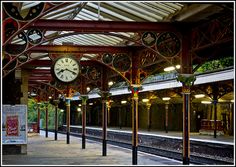 a train station with a clock on the wall