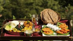 there are many different foods on the trays that is ready to be eaten and served