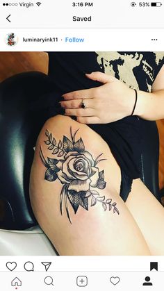 a woman sitting on top of a chair with a flower tattoo on her thigh and leg