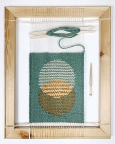 an image of a weaving project with yarn and scissors on the table next to it