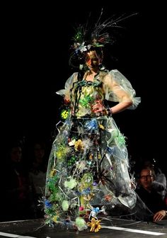 a woman in a dress made out of plastic bottles