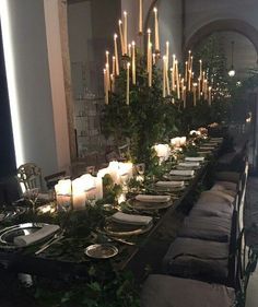 a long table is set with candles and plates