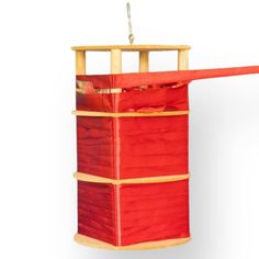 a red and yellow hanging storage unit with two shelves on each side, one shelf has an umbrella attached to it