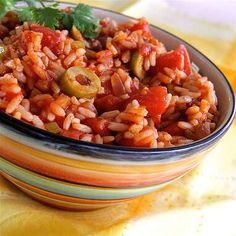 a bowl filled with rice and vegetables on top of a table