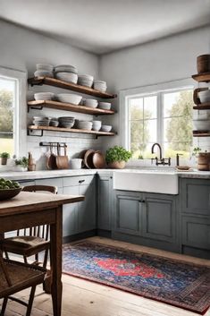 a kitchen filled with lots of open shelves and dishes on top of the counter tops