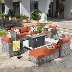 an outdoor patio furniture set with orange cushions