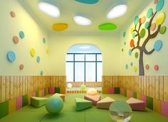 the room is decorated in bright colors and has round balls on the floor, as well as colorful circles hanging from the ceiling