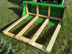 the back end of a green truck with wooden slats