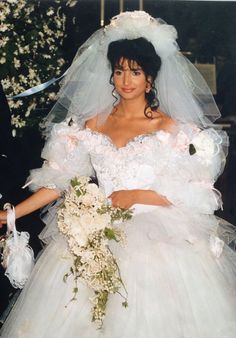 a woman in a wedding dress holding a bouquet