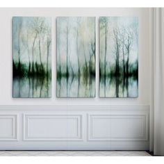 three paintings are hanging on the wall in a room with white walls and flooring