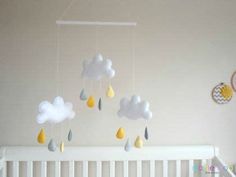 a crib with some clouds and raindrops hanging from it