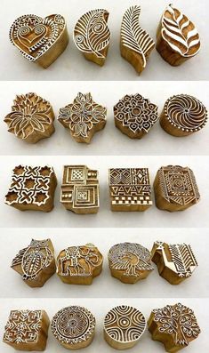 several different shapes and sizes of carved wooden stamps with designs on the front, back and sides