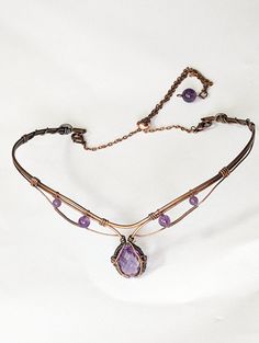 Enhance your look with this stunning 6ct Amethyst choker in copper! Handcrafted with quality materials, this choker features a beautiful Amethyst gemstone in the center, set in copper wire wrap that creates a beautiful and eye-catching design. The copper wire wrap is intricately detailed and flows gracefully around the gemstone, giving it an elegant feel. The choker fits comfortably around the neck and is lightweight enough to be worn all day. You'll be sure to make a bold statement with this un Wire Necklace Patterns, Wire Wrap Bracelet With Stones, Luxury Wire Wrapped Jewelry Gift, Wire Necklace Designs, Wire Wrapped Clasps, Copper Wire Necklace, Fantasy Wire Jewelry, Wire Choker Necklace Diy, Wire Wrap Choker