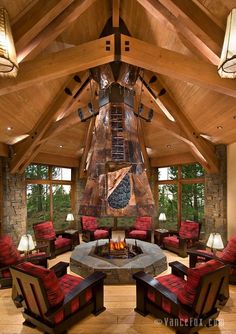 a living room filled with lots of furniture and a fire place in the middle of it