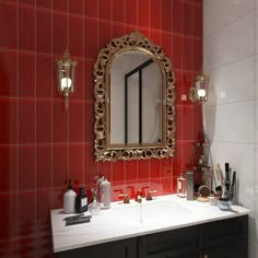 a bathroom with red tile and gold mirror on the wall above the sink, along with other accessories