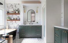 a bathroom with green cabinets and white walls