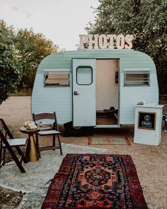 an old camper is parked on the side of the road with its door open