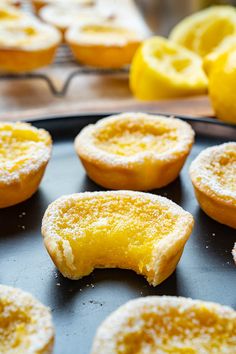 some lemon pastries are sitting on a black plate and ready to be baked in the oven